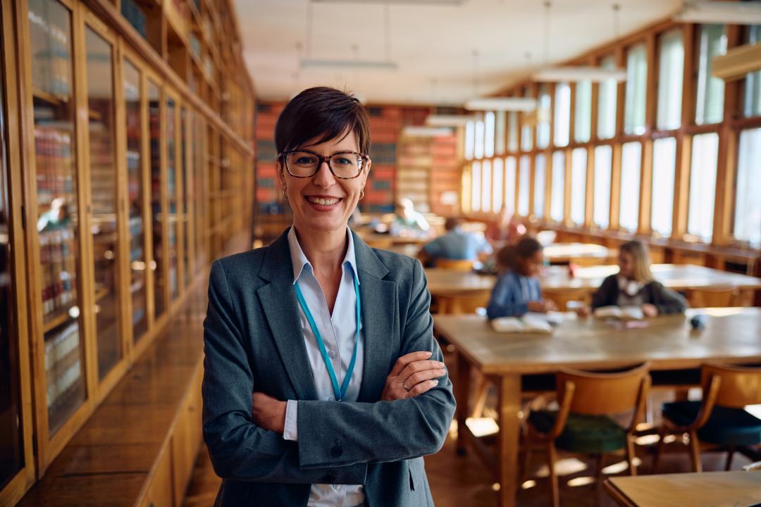 Confident school administrator in library