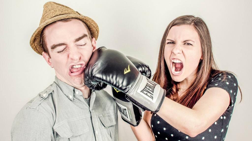 One person hitting another with boxing gloves
