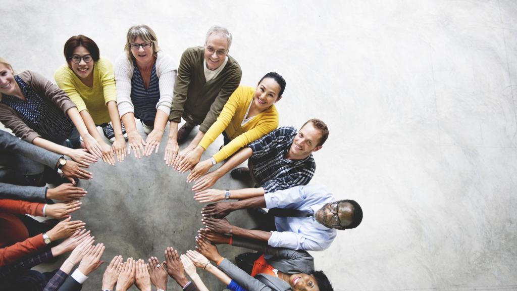 People joining hands in a circle