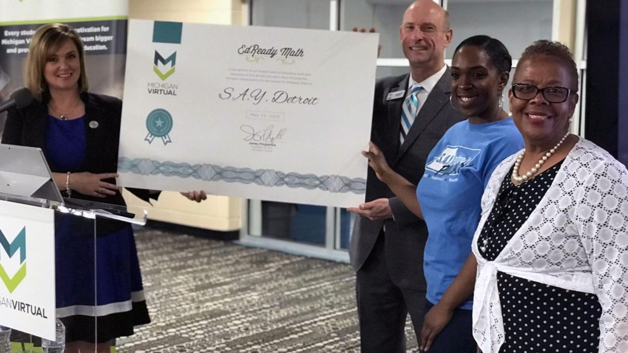 Presenting a certificate for EdReady math to the S.A.Y. Detroit organization