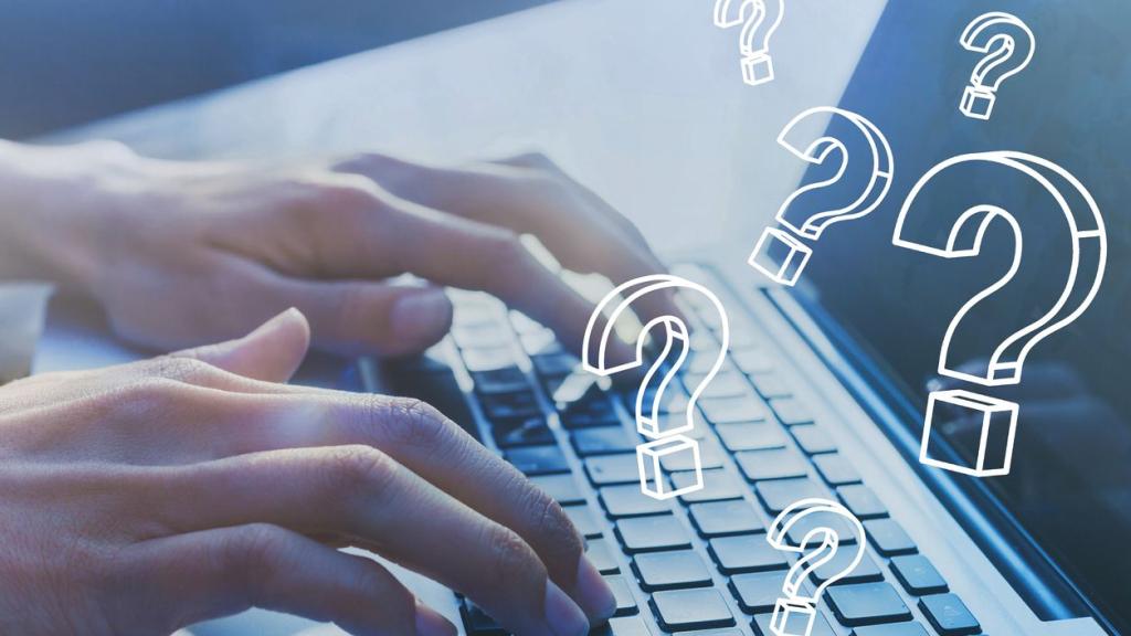 person using a laptop with question marks