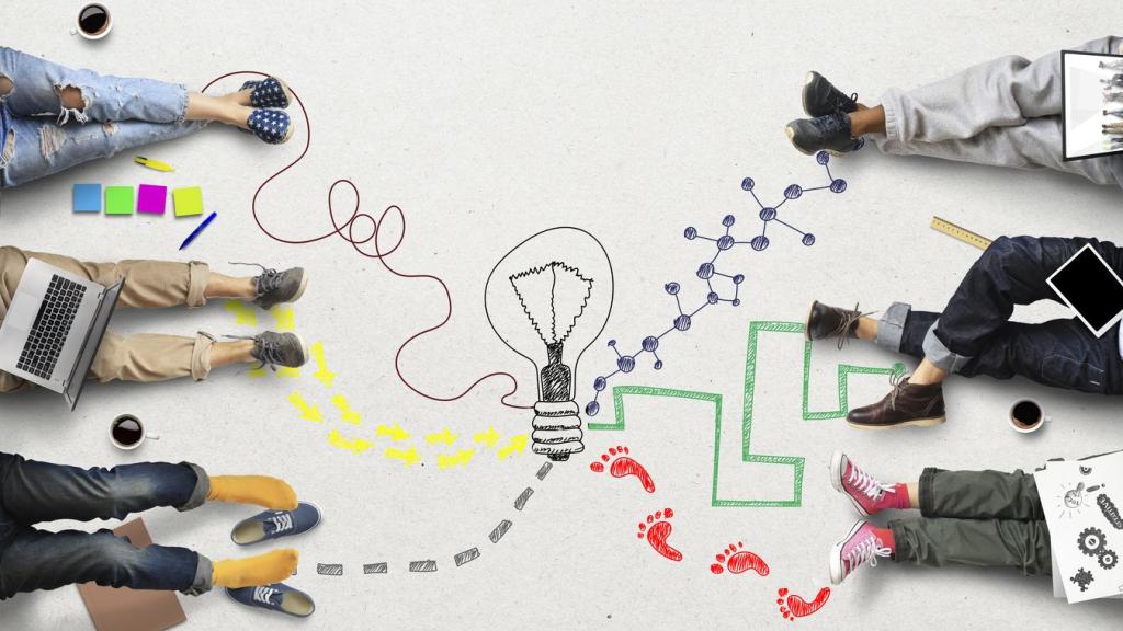 Students sitting on the ground with different colored pathways tracing their way to a lightbulb in the center
