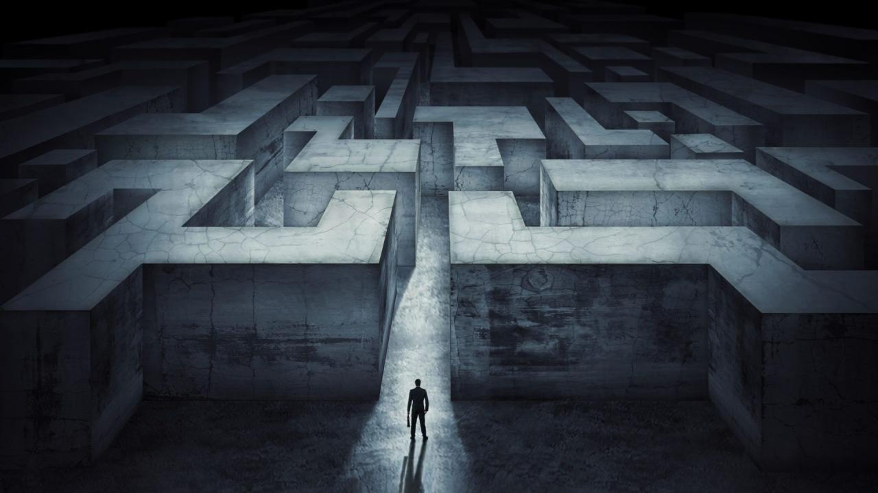 illustration of man standing before the entrance of a maze