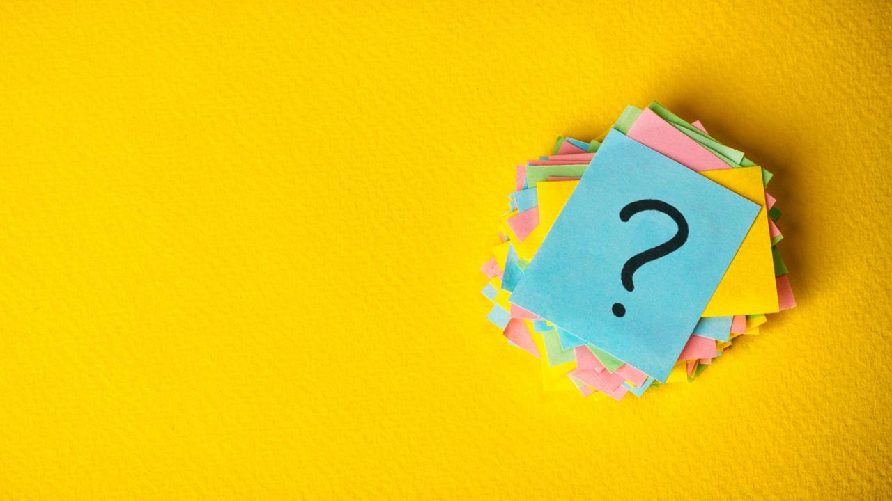 question mark on sticky note against yellow background