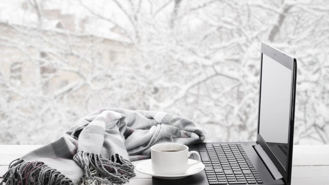 Laptop and coffee on winter window