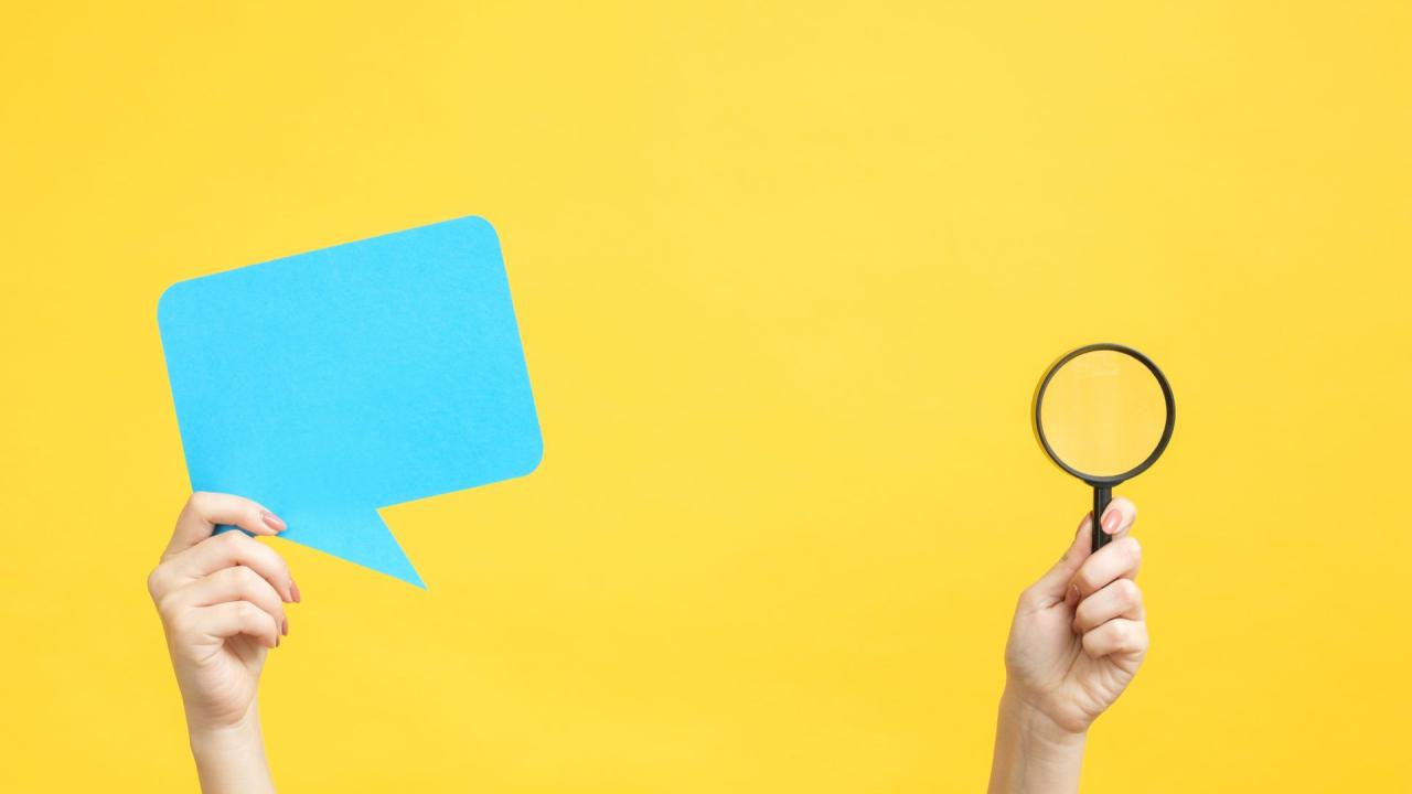 speech bubble and magnifying glass against yellow background