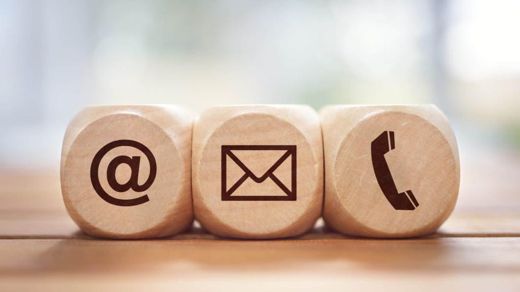 wooden blocks with @ symbol, envelope, and phone call symbol