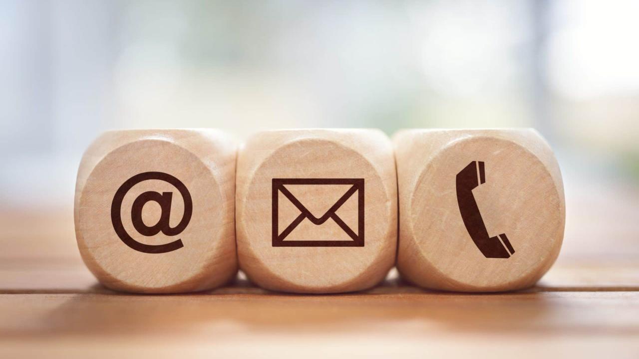 wooden blocks with @ symbol, envelope, and phone call symbol