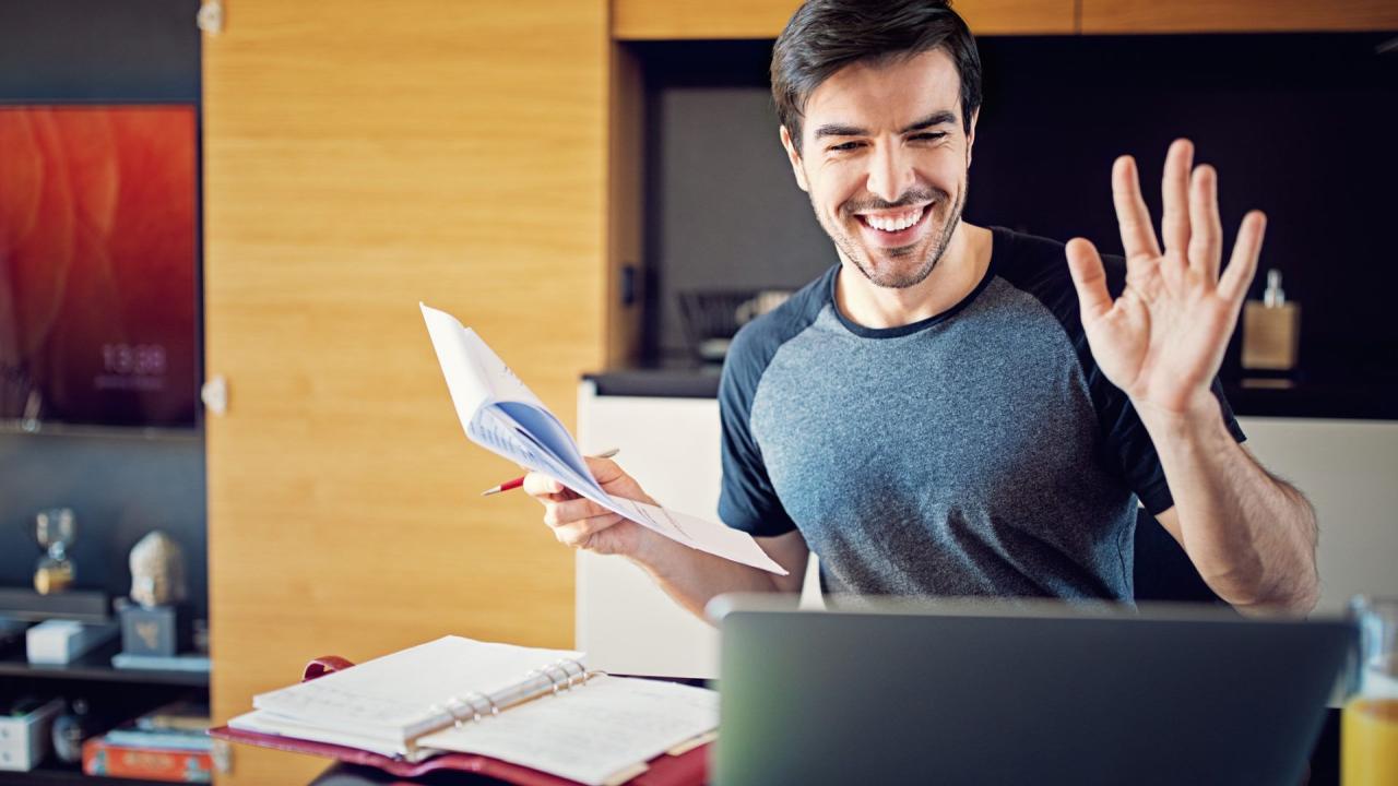 Man is working at home and video conferencing using his laptop