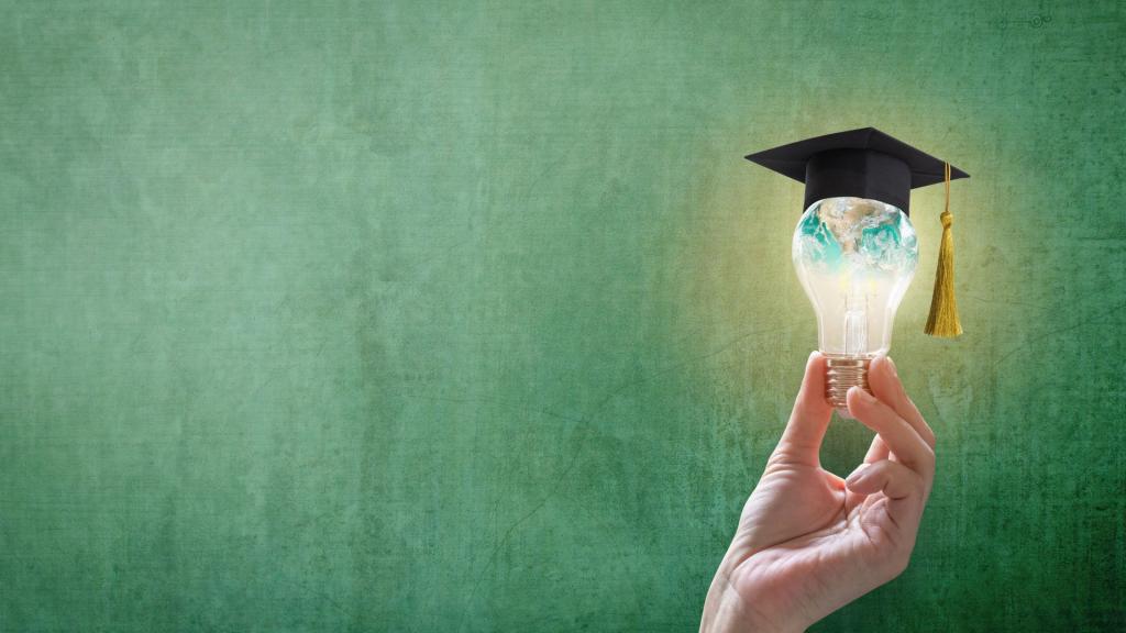 Innovative learning, creative educational study concept for graduation and school student success with world lightbulb on teacher chalkboard