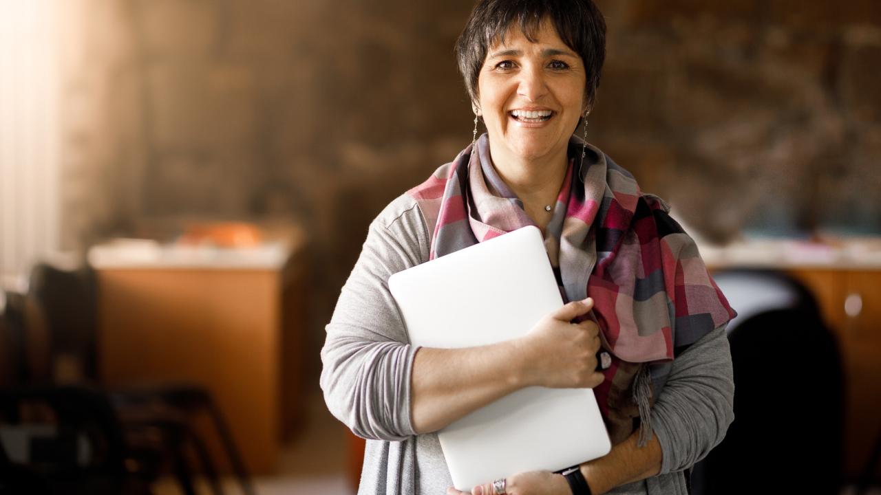Adult student holding laptop