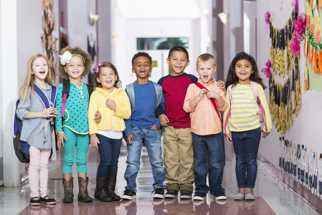 Multiracial group of children in preschool hallway