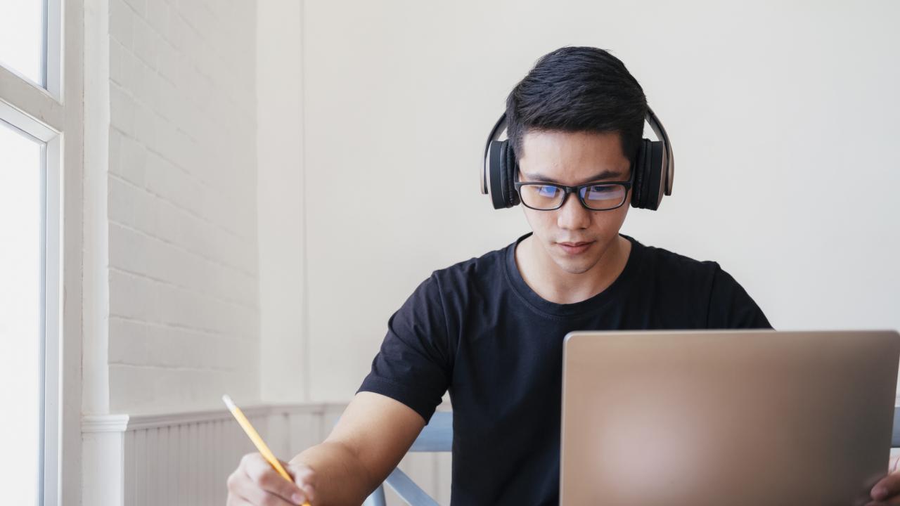 Young man student study at home using laptop and learning online.
