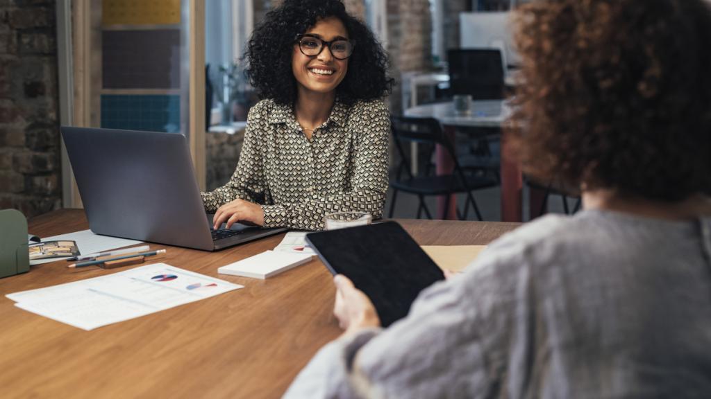 Two businesswomen working together at the office.