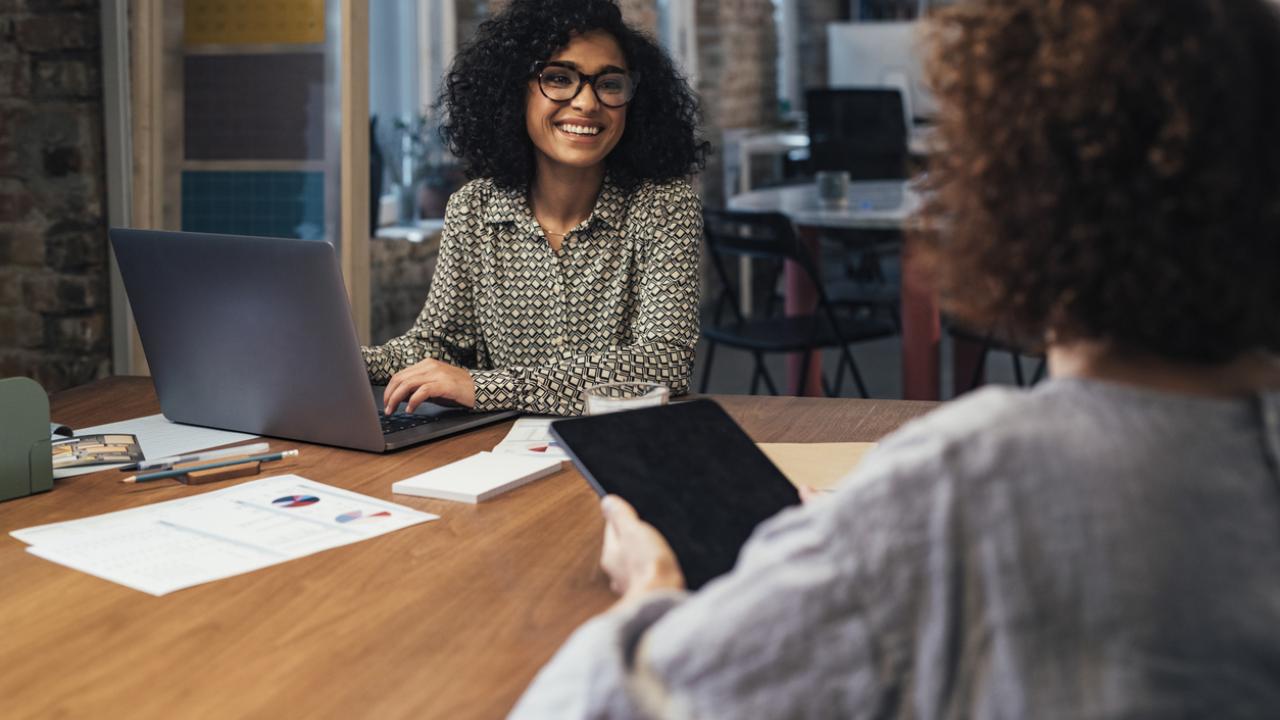 Two businesswomen working together at the office.