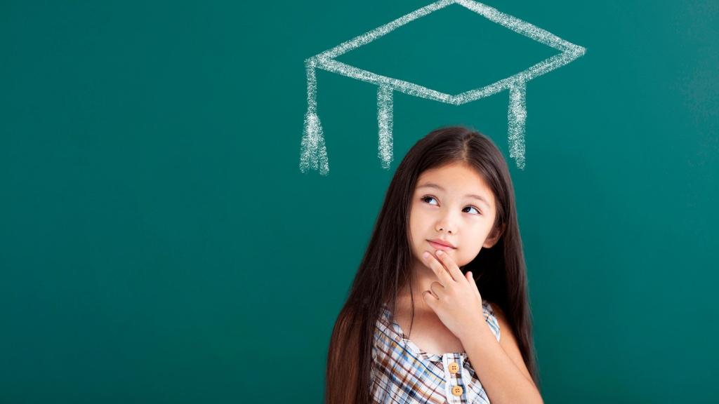 Girl on chalkboard with graduation cap drawn above her head