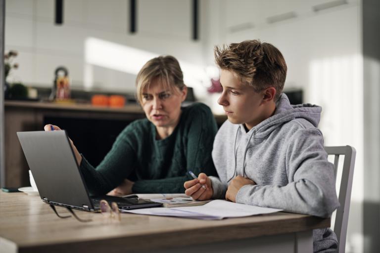 Parent and teen with laptop