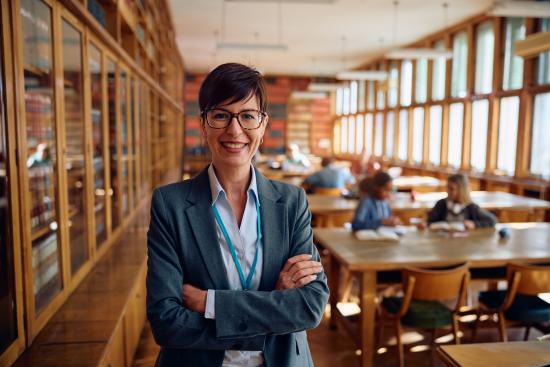 Confident school administrator in library