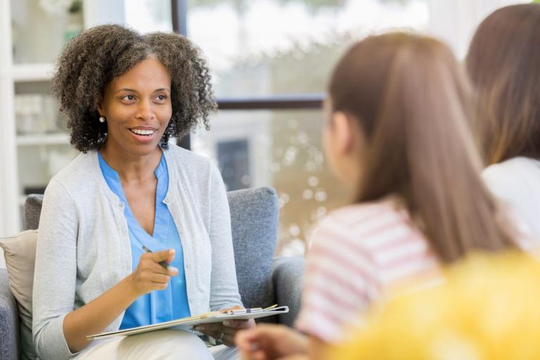 Mental health professional speaks candidly with two patients