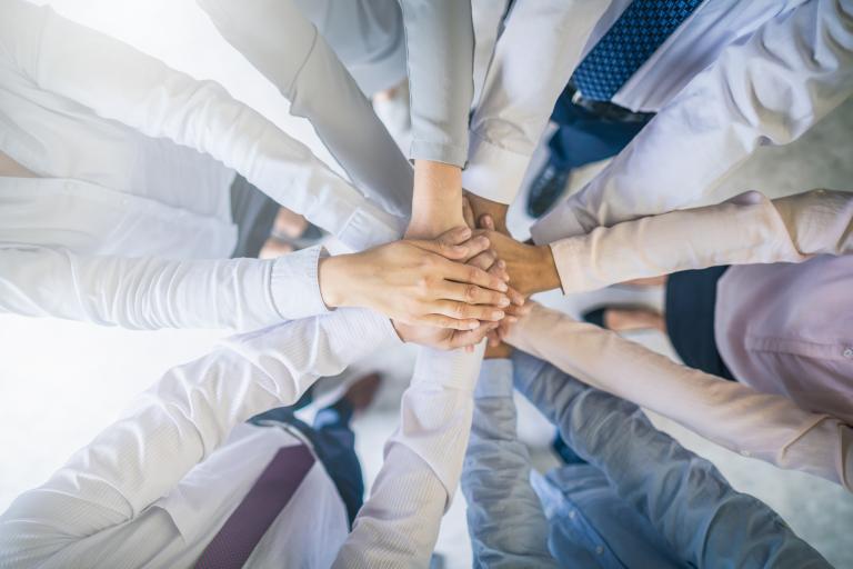 Stack of hands. Unity and teamwork concept.