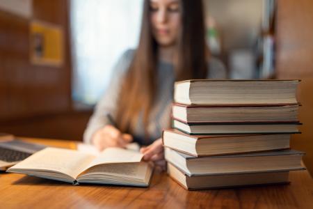 Pile of books on the table in the library