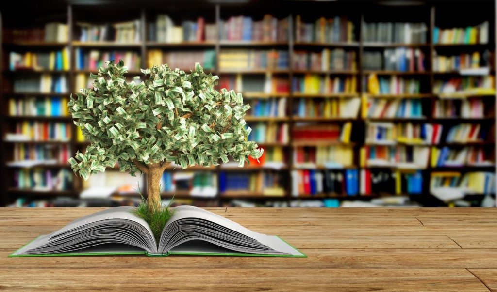 A money tree coming out of a book in a library