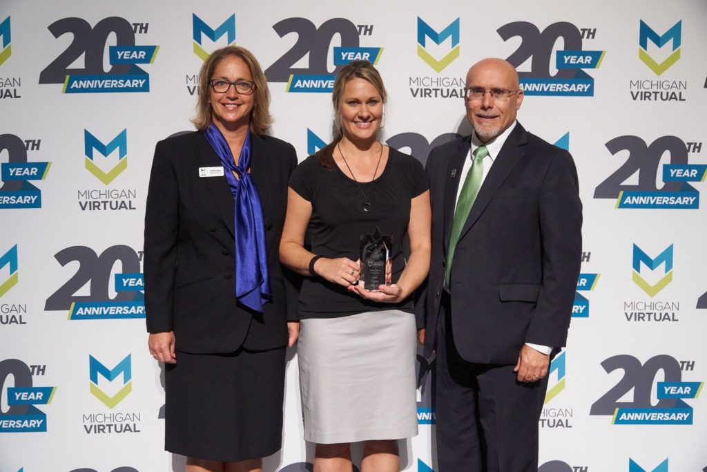 Lori Coyle accepts award from Jamey Fitzpatrick and Kristin Flynn