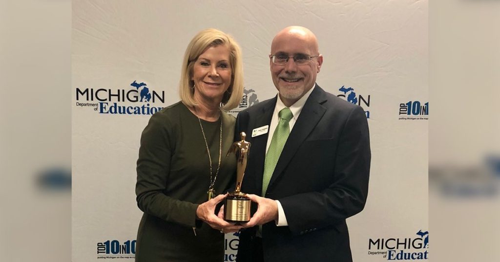 Sheila Alles (Michigan's Interim State Superintendent) and Jamey Fitzpatrick (President and CEO of Michigan Virtual) hold the 2018 Telly Award