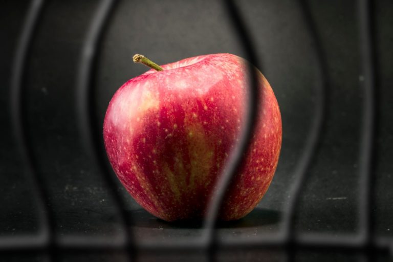 An apple behind prison bars