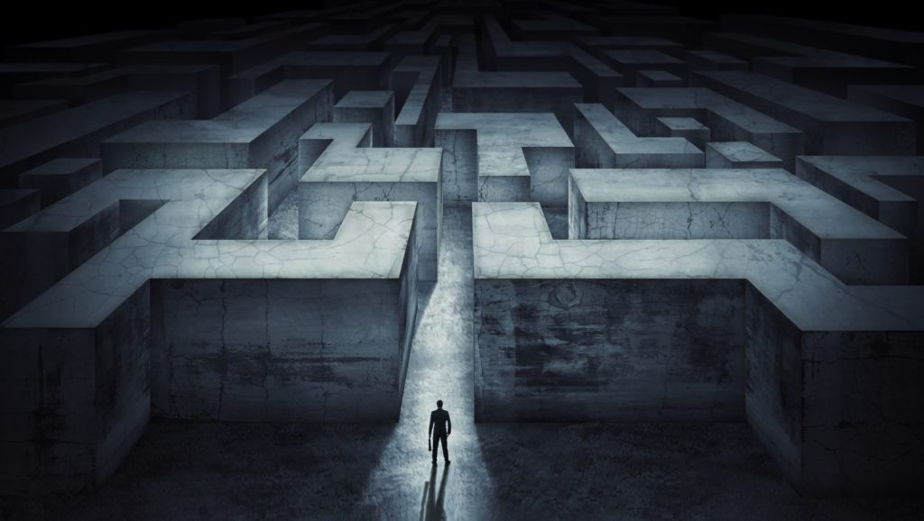 illustration of man standing before the entrance of a maze