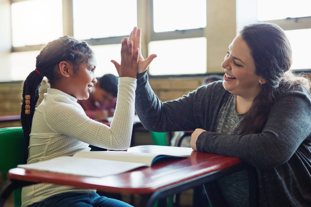 teacher giving a student a high five