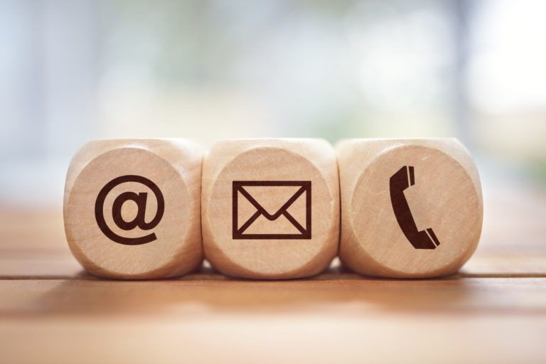 wooden blocks with @ symbol, envelope, and phone call symbol